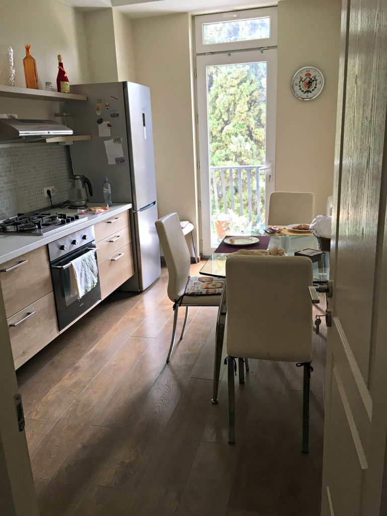 Tbilisi Airbnb kitchen with light from glass door balcony