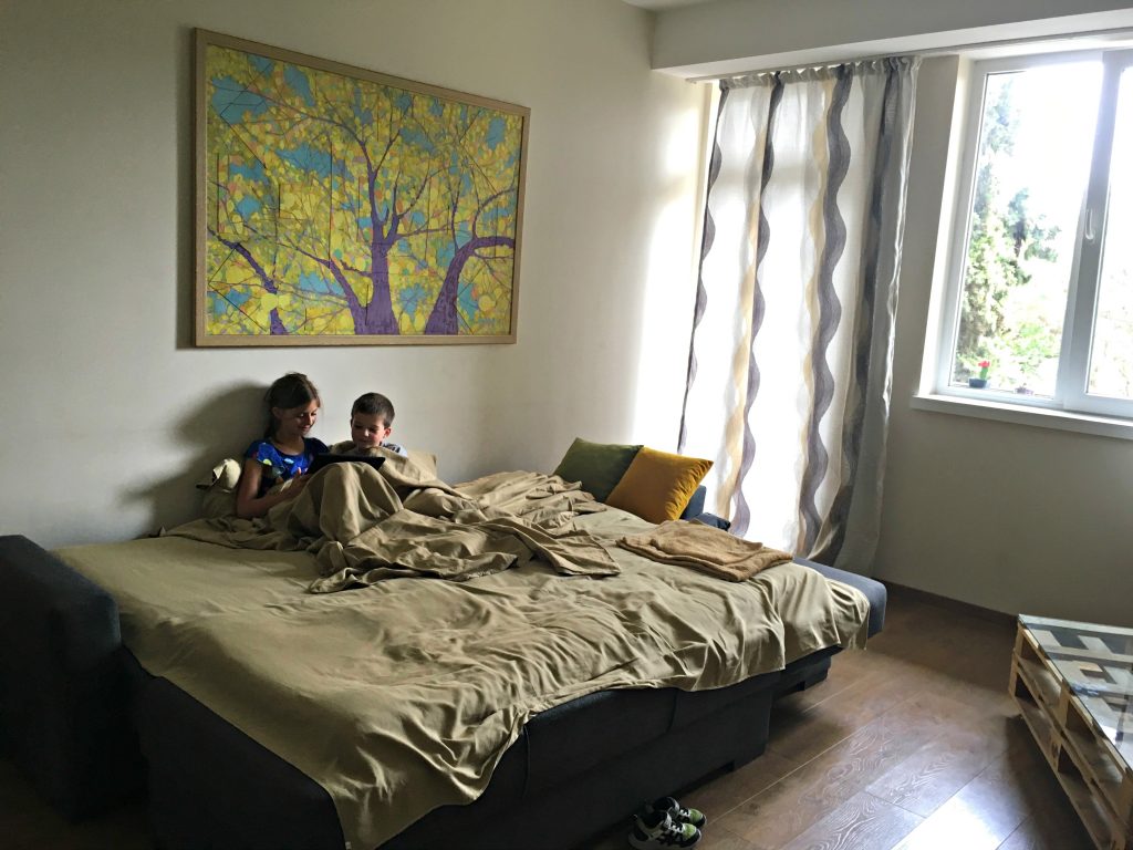Tbilisi Airbnb living room with kids on the couch
