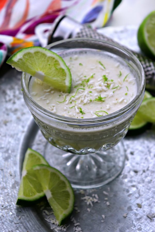 Coconut lime dessert mousse side view with lime slices