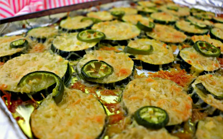 Easy low carb grilled garlic parmesan zucchini, the perfect summer Keto side dish. Picnics and get togethers, everyone will love this gluten-free recipe. #lowcarbsides #zucchini