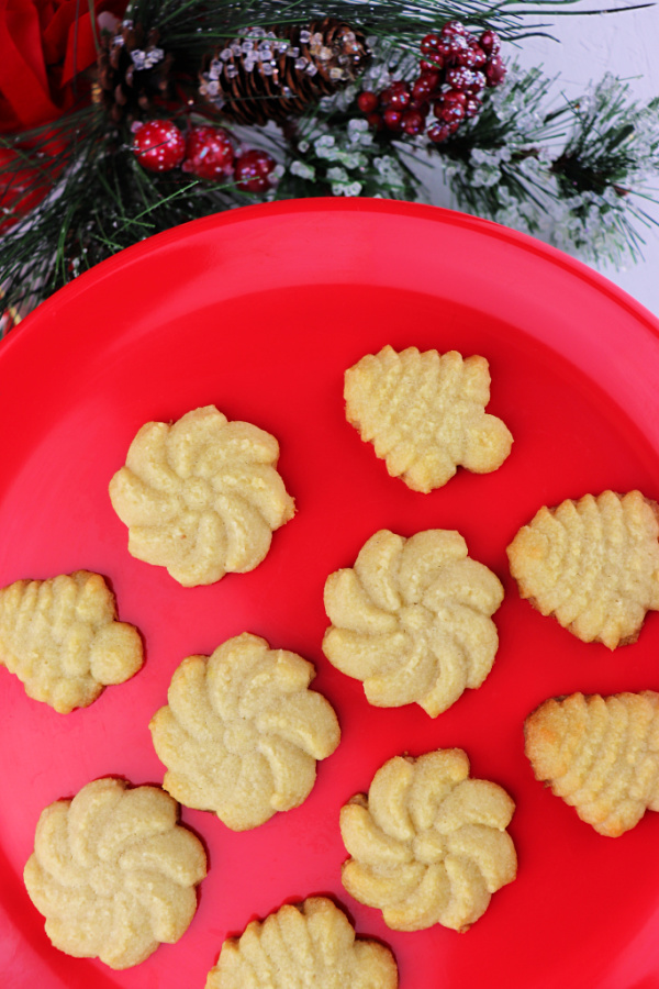 Keto butter spritz cookies on a red plate