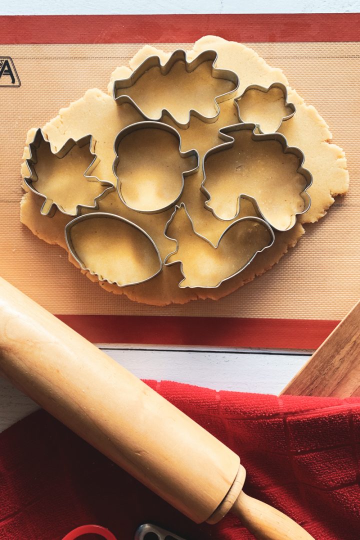 Dough on a mat with cookie cutters