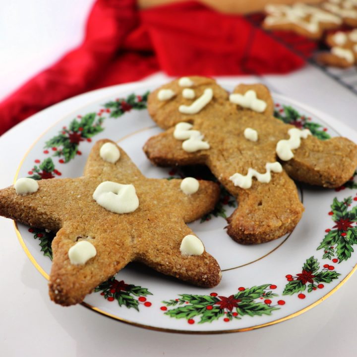 Keto gingerbread cookies on a Christmas plate. Gluten-free, sugar free, low carb ginger classics. #ketocookies #lowcarbcookies