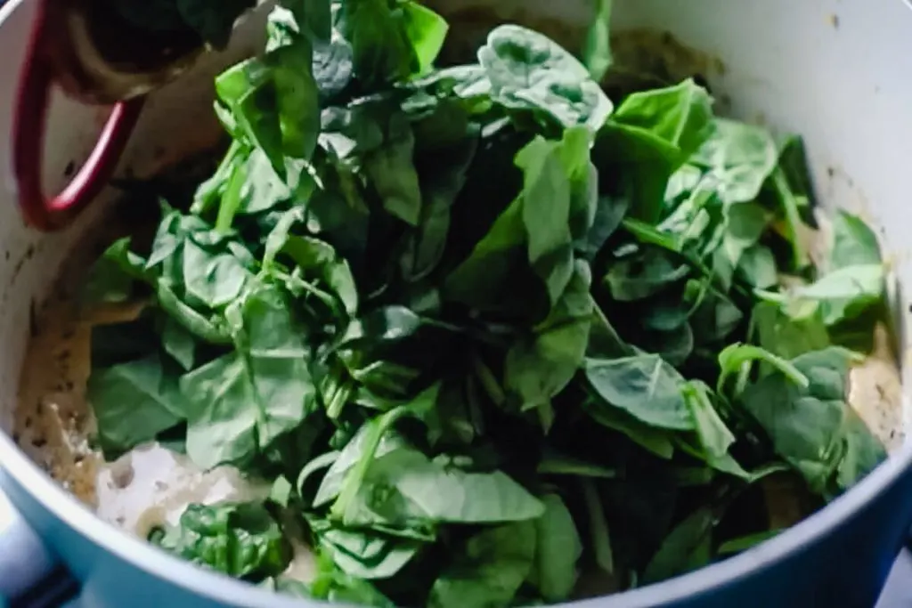 Spinach going in the soup