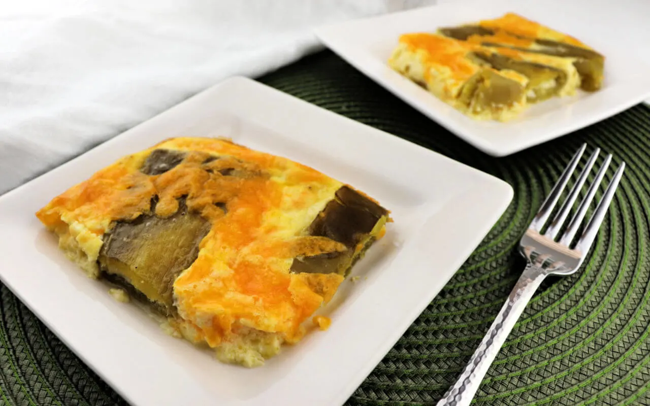 Keto Breakfast Casserole, chiles rellenos, two pieces on white square plates