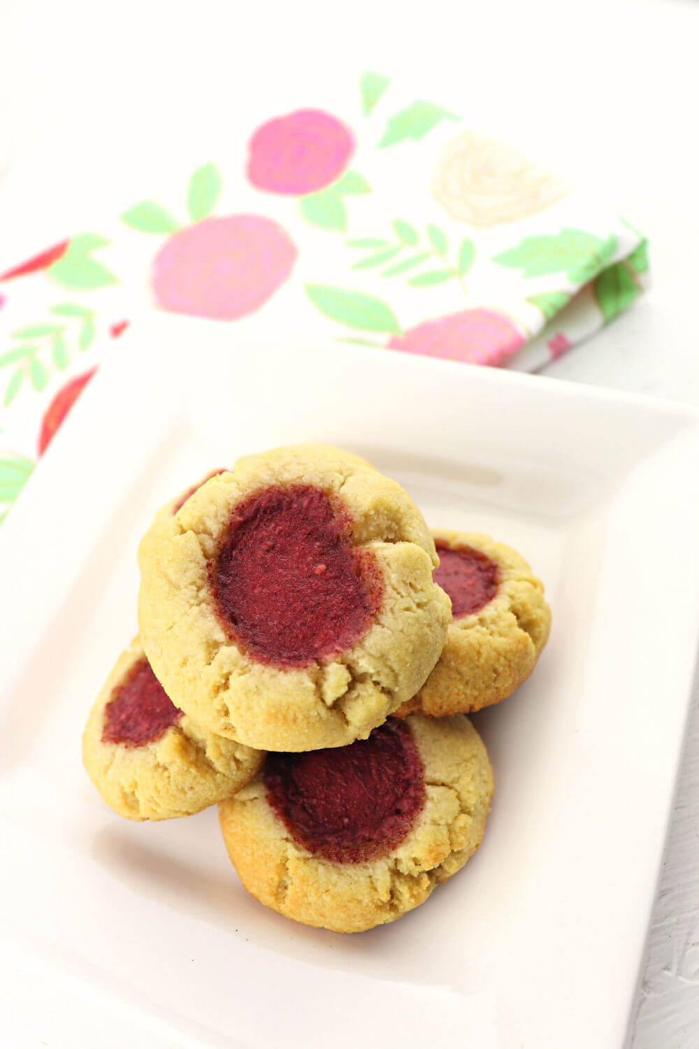 Butter and jam keto thumbprint cookies are delicious, kid-friendly, and low carb! Buttery melt in your mouth gluten-free, sugar-free goodness. #ketocookies #lowcarbdesserts