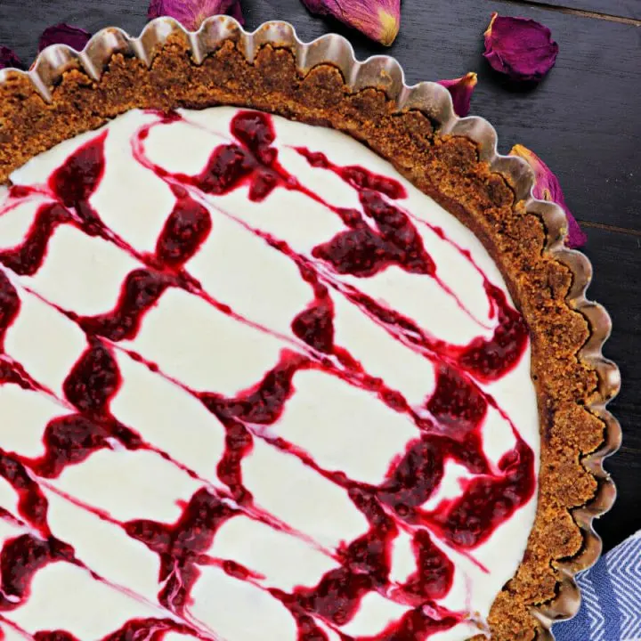 Keto bakewell tart is the perfect summer dessert! The flavors of fresh raspberries and almonds in a creamy tart with almond flour shell. #ketodessert #lowcarbdessert