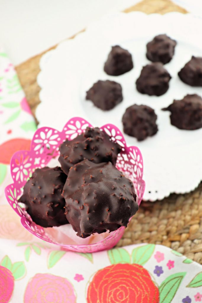 Delicious keto chocolate coconut balls are the perfect gluten-free sugar-free holiday candy to keep around during Easter, Christmas, or whenever you need a low carb alternative to candy! #ketocandy #lowcarbdessert