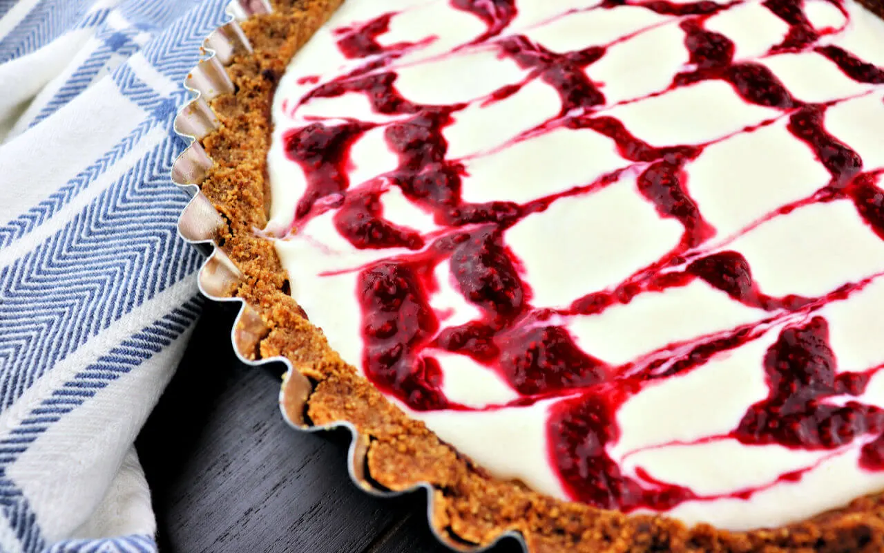 The best almond raspberry keto bakewell tart. A super special low carb dessert sure to impress. With a gluten-free almond flour crust and sugar-free frangipan filling, it's sure to be a hit! #ketodessert #lowcarbrecipes