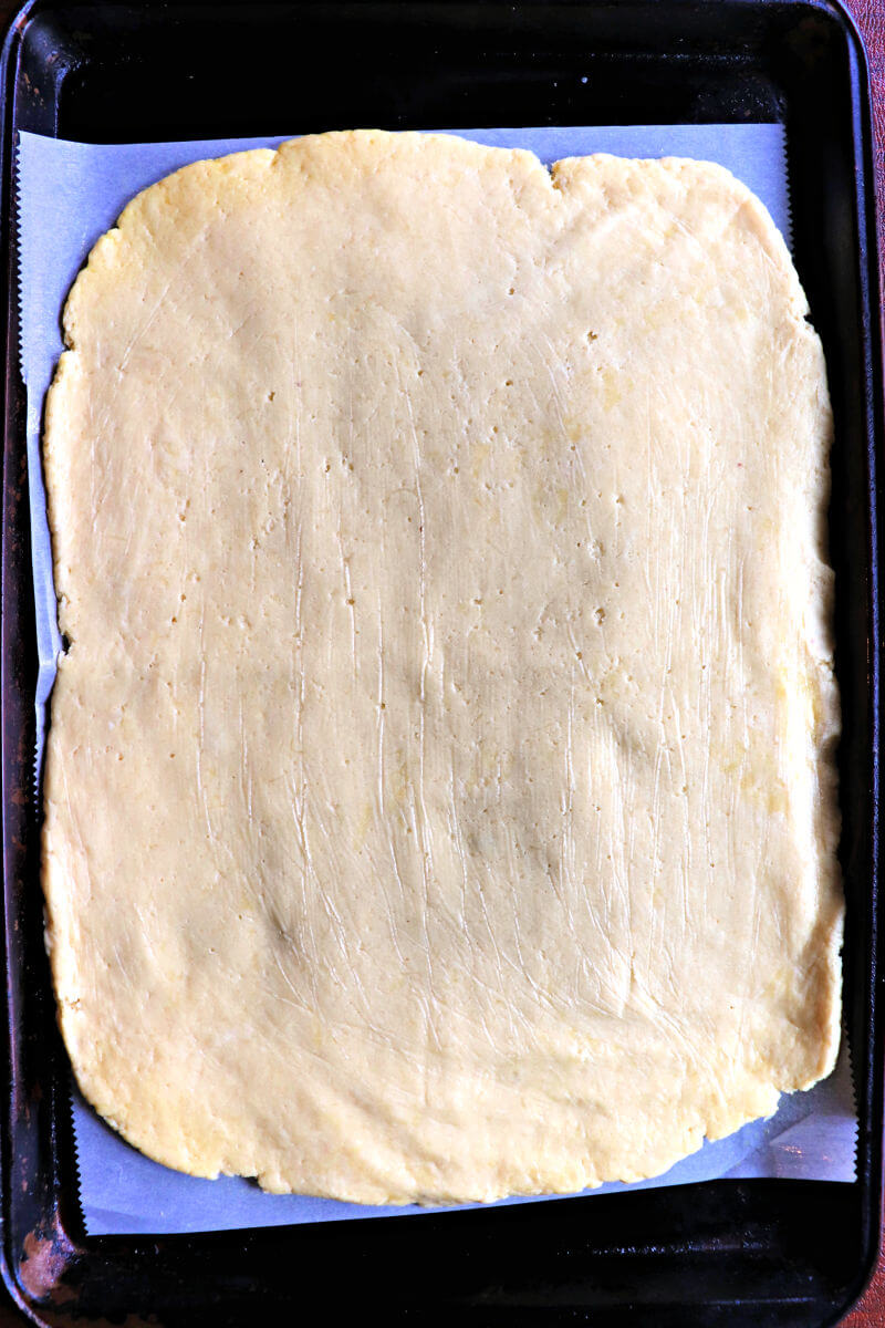 Keto pesto pinwheels dough in a rectangle shape