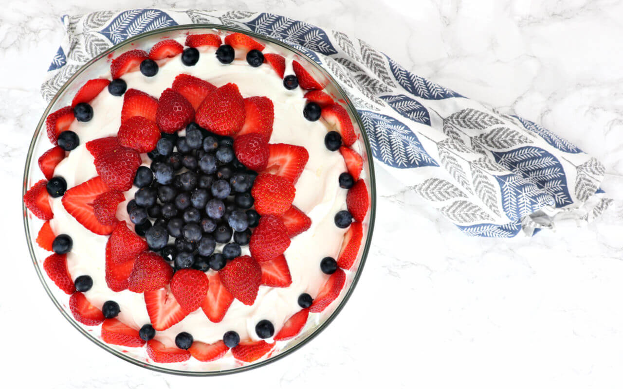 The best Keto Berry Trifle is a delicious centerpiece for Memorial Day, the Fourth of July, or any summer party. Filled with gluten-free, sugar-free lemon pound cake, custard, berries, and cream, what's not to love!? #ketodesserts #lowcarbdesserts