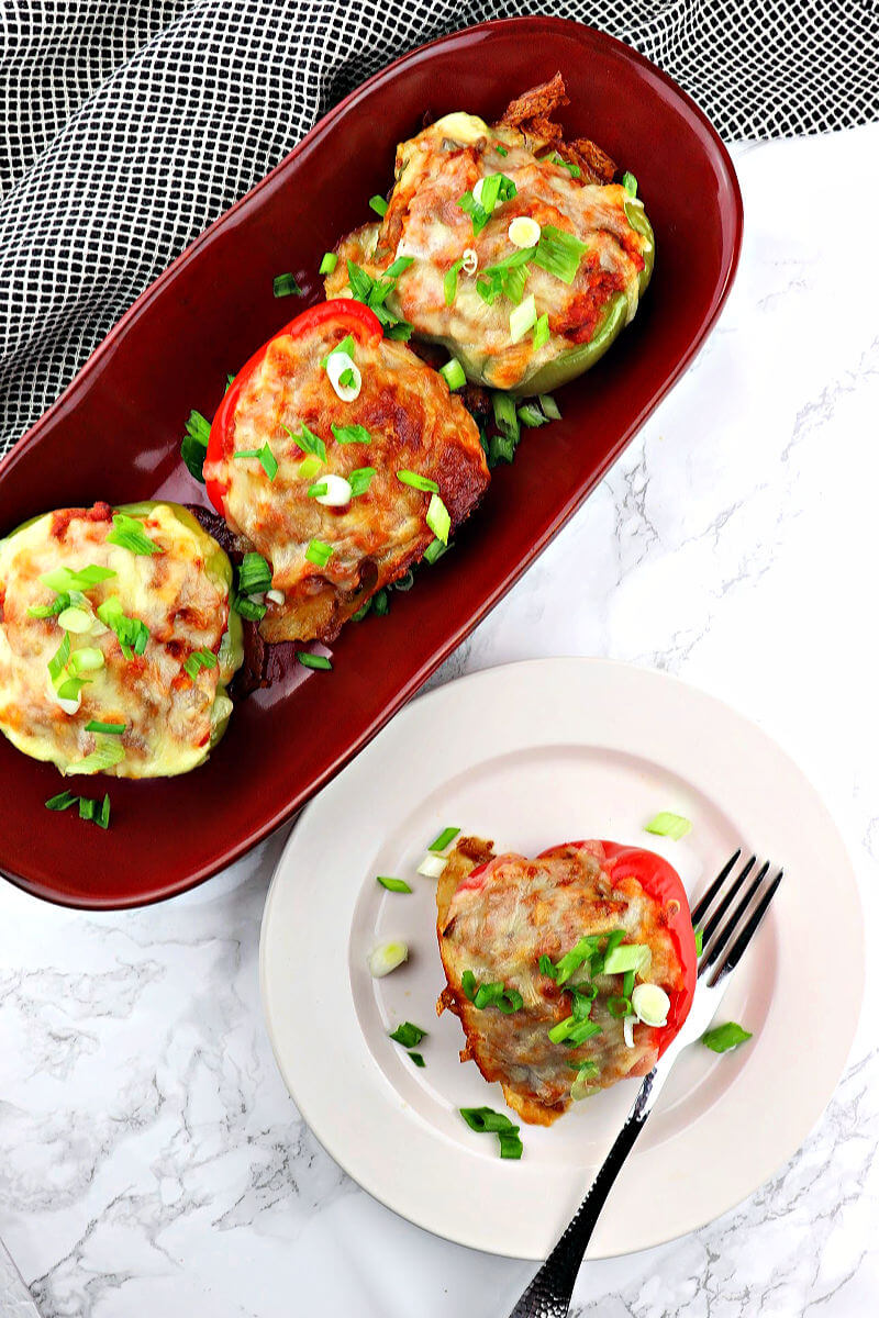 Keto sausage stuffed peppers with Italian spices are gluten-free goodness. A low carb meal filled with cauliflower rice, sausage, cheese, and more! #ketodinner #ketostuffedpeppers #lowcarbdinner