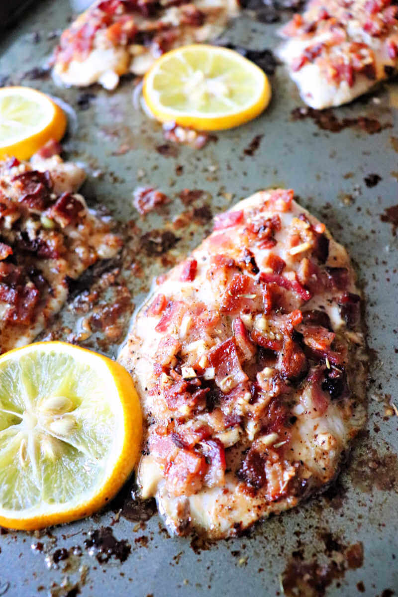 Bacon smothered keto tilapia is a burst of flavor to your taste buds. Bacon in a lemon garlic butter sauce is gluten-free and sure to please for a family dinner. #ketorecipes #ketodinners