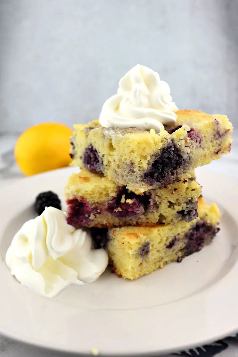 Stack of keto blackberry cobbler is a low carb feast for the eyes! Full of fresh lemon and blackberry flavors and a popular sugar-free tray bake for a group. #ketodessertrecipes #ketodesserts #ketorecipes