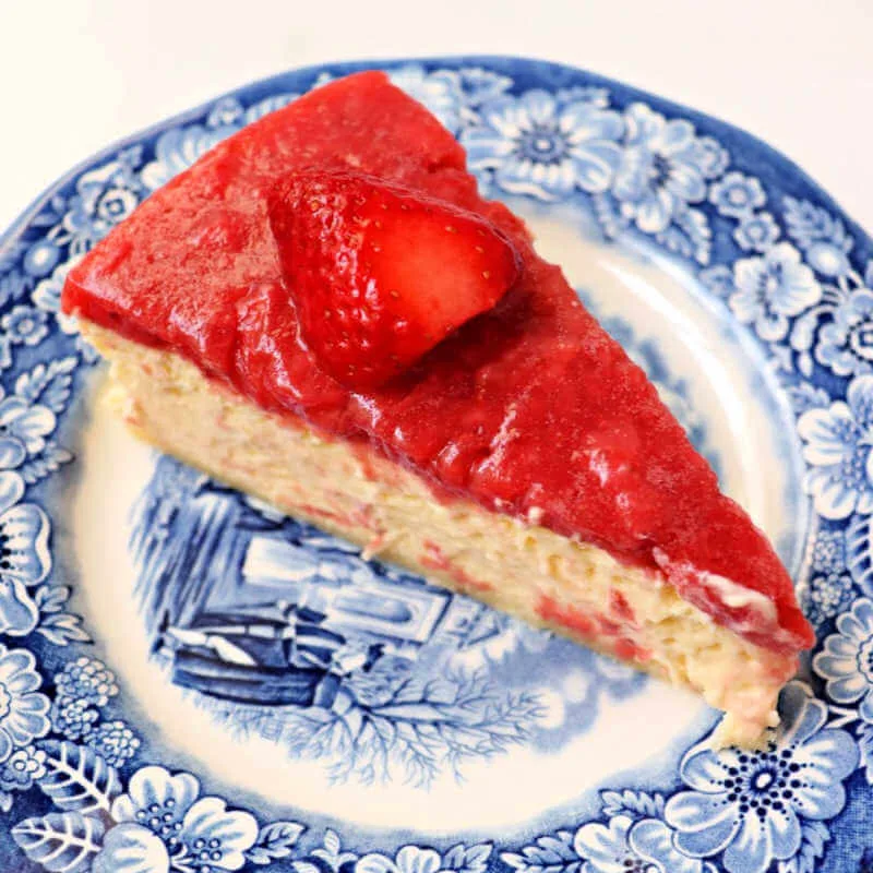 Piece of keto strawberry cheesecake on a plate. #ketocheesecake #ketodesserts #ketovalentine