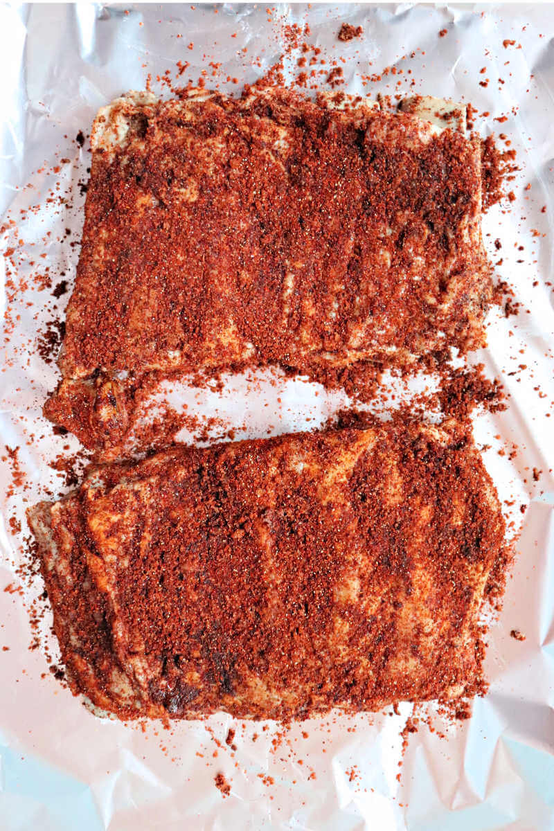 Keto pork ribs with spicy rib rub. Generously spread the spice mixture over the ribs. #ketoribs #ketorecipes #ketoribrub