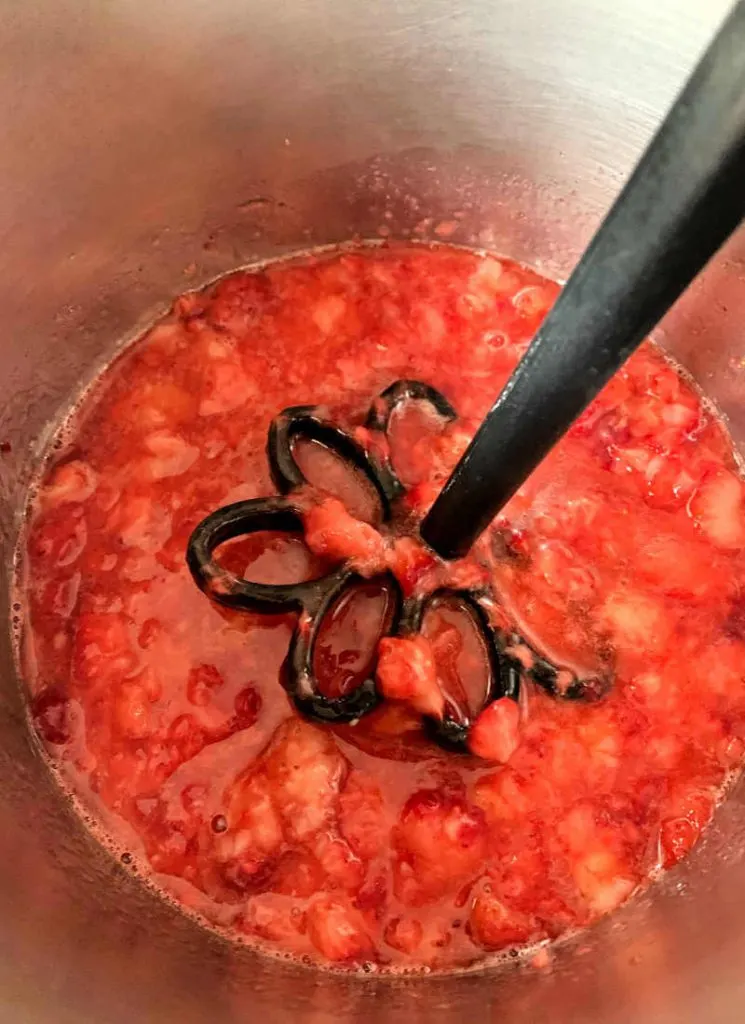 Smashing the strawberries for the sauce. #ketocheesecake #ketorecipes