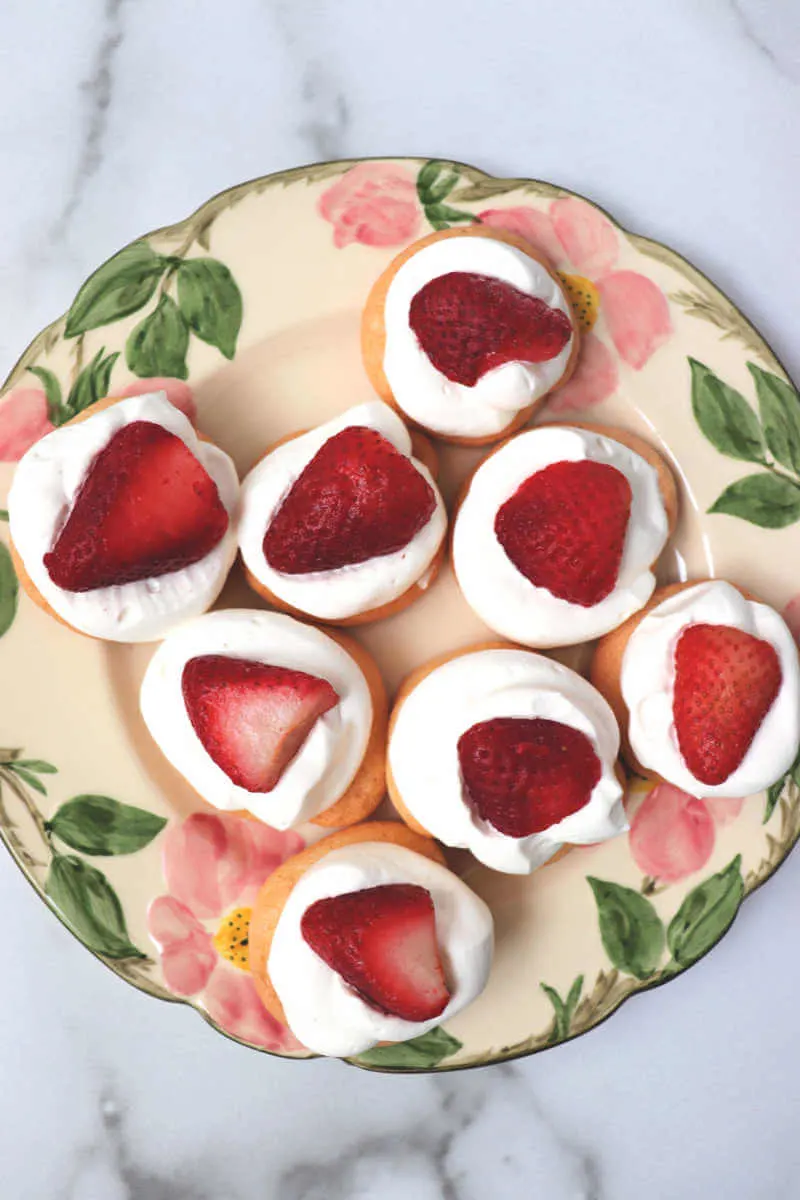 Plate of strawberry keto meringue cookies. #ketorecipes #ketodesserts