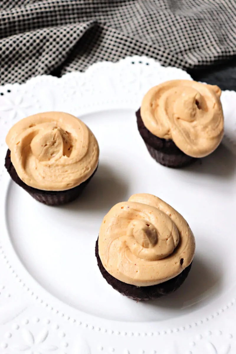 Overhead keto peanut butter frosting on gluten-free chocolate cupcakes. #ketofrosting #ketorecipes #ketodesserts