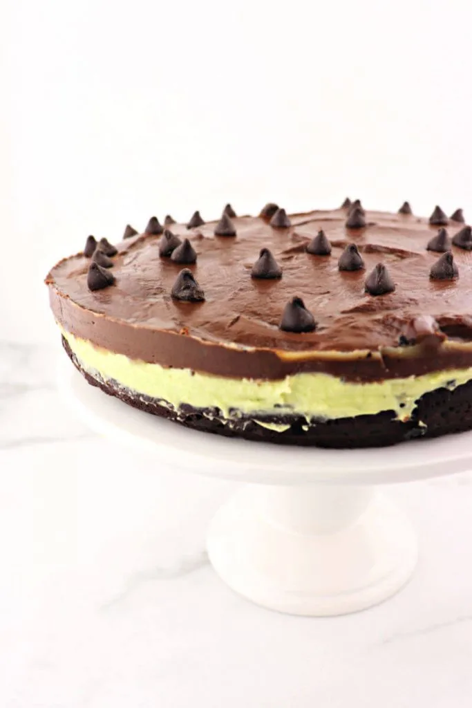 Keto flourless chocolate grasshopper cake pairs divinely rich dark chocolate with a sugar-free creamy mint filling naturally colored with avocado. The ideal low carb dessert for St. Patrick's Day or any holiday. #ketodessert #ketocake