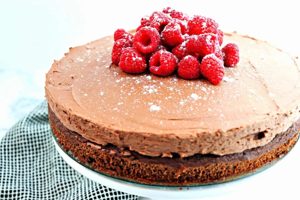 Moist and yummy keto chocolate mousse cake topped with raspberries.