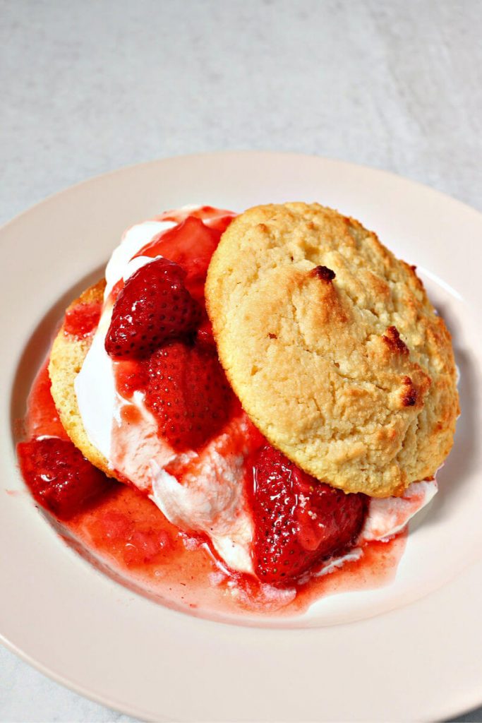 Keto strawberry shortcake is real food yum. Gluten-free biscuit with homemade whipped cream and strawberries. #ketorecipes #ketodesserts