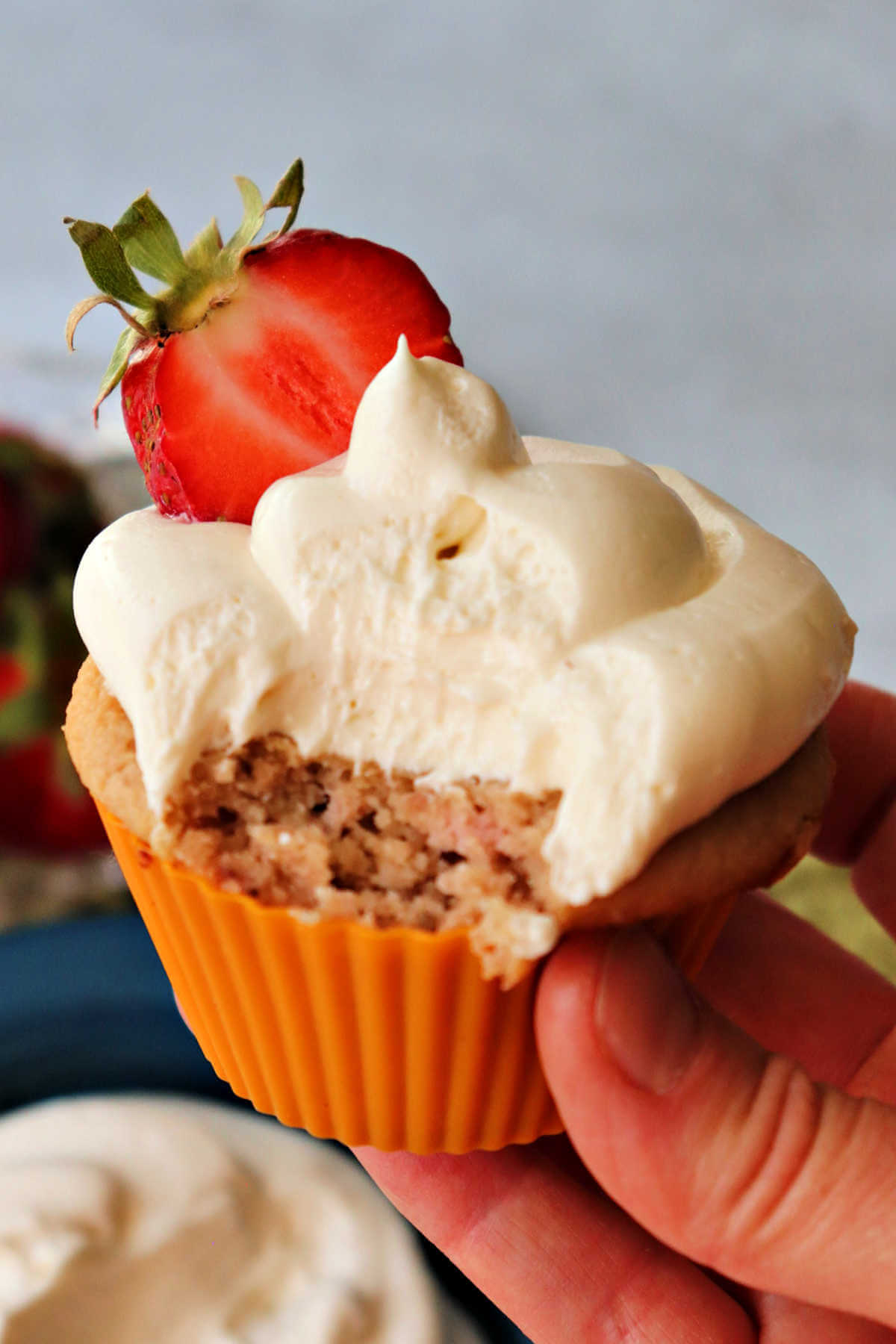 Delicious keto cream cheese frosting on a low carb strawberry cupcake.