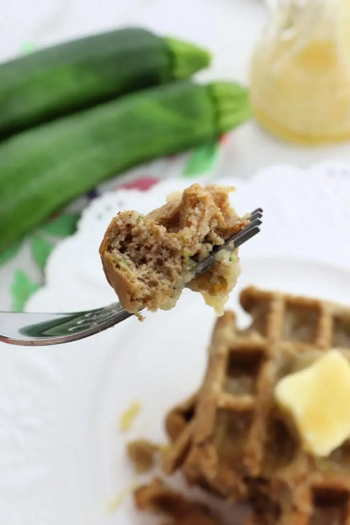 Bite on a fork of a keto zucchini waffle