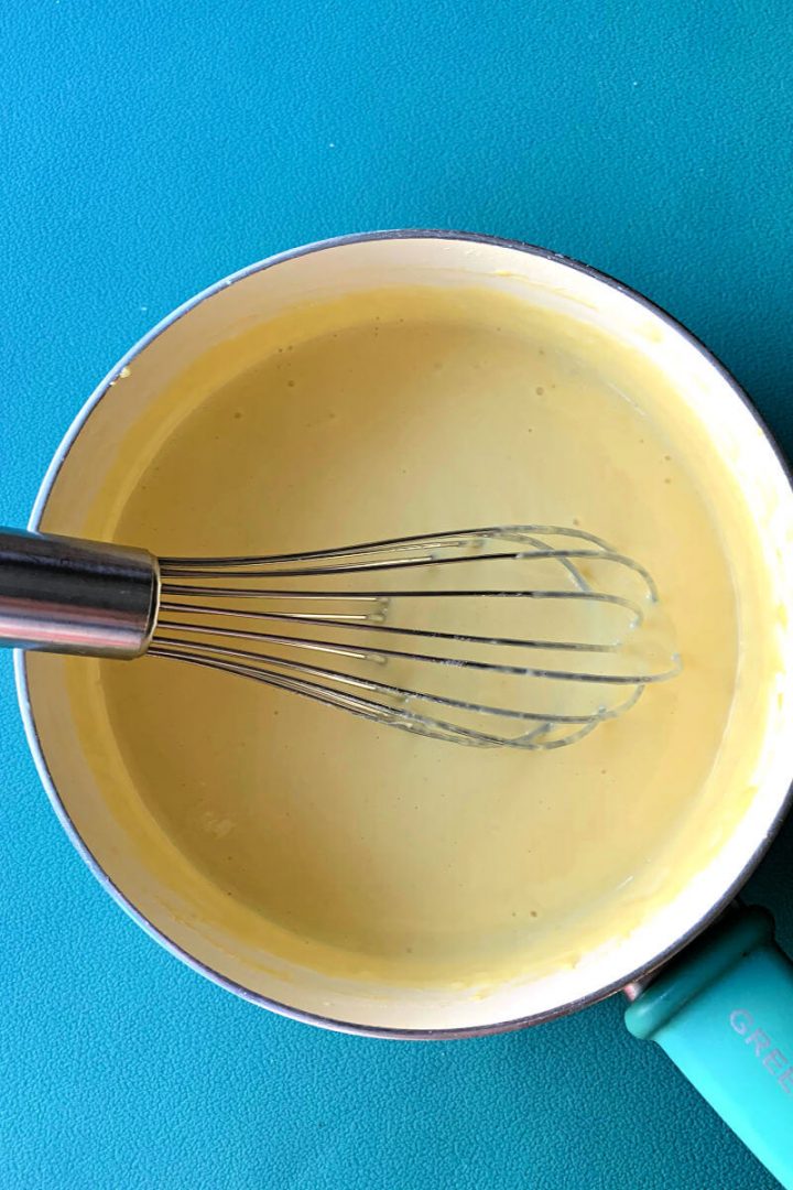 Keto custard cream in a saucepan with a whisk