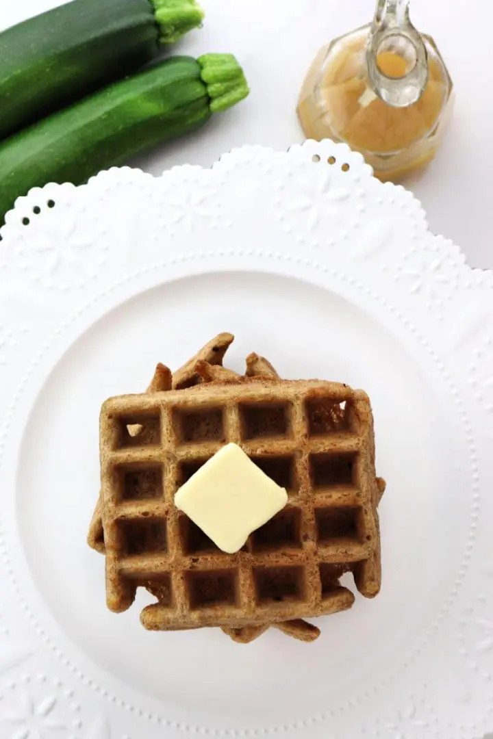 Overhead keto zucchini waffles with zucchini and syrup