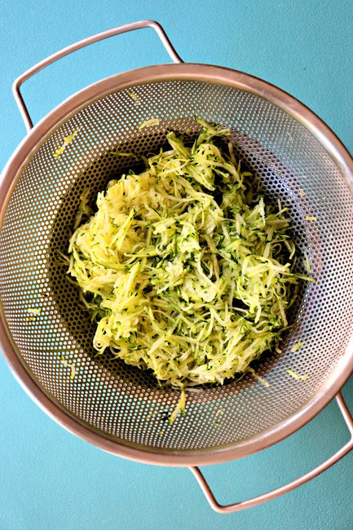 Shredded zucchini in a colander