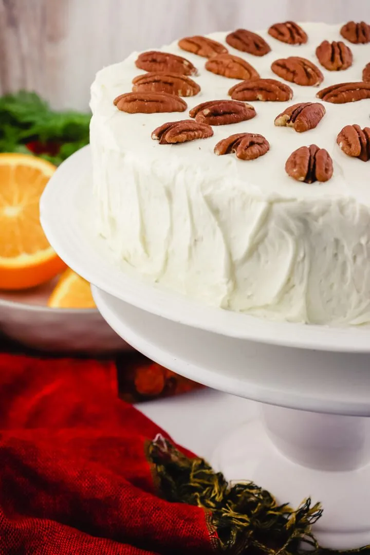 Keto carrot cake with pecans on a pedestal