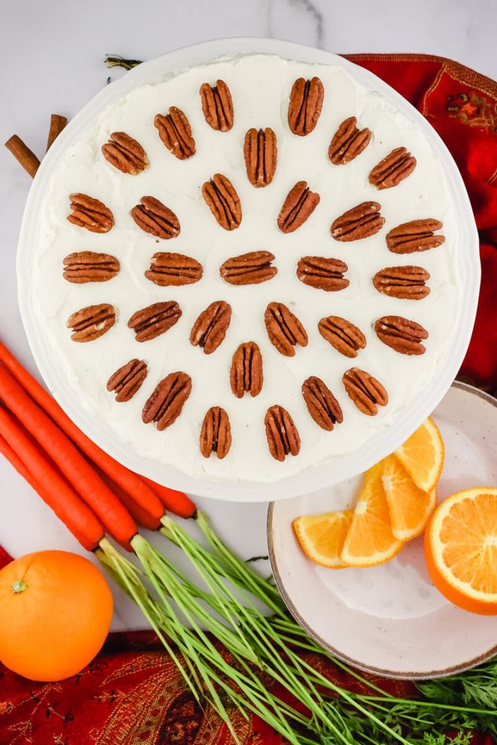 Keto carrot cake overhead view with carrots and oranges