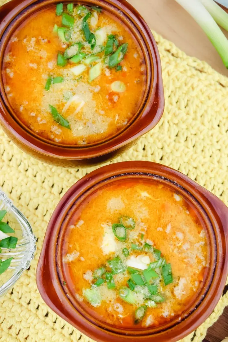 Overhead two bowls of keto hot and sour soup with pork