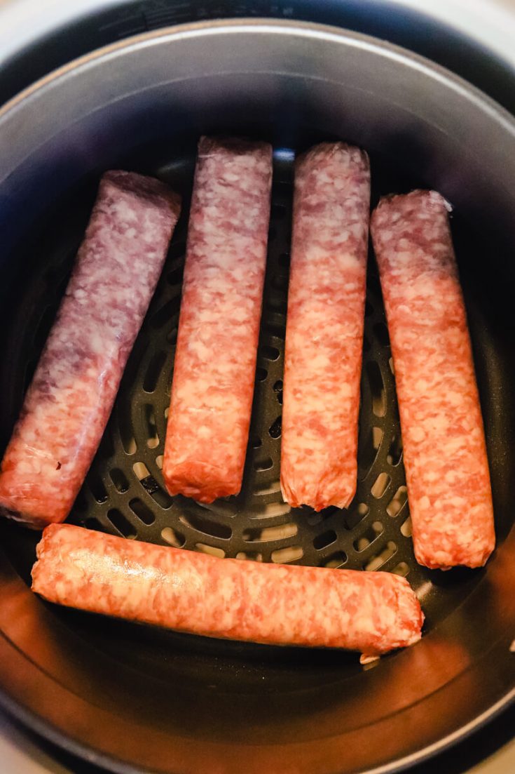 Overhead view of brats in the air fryer
