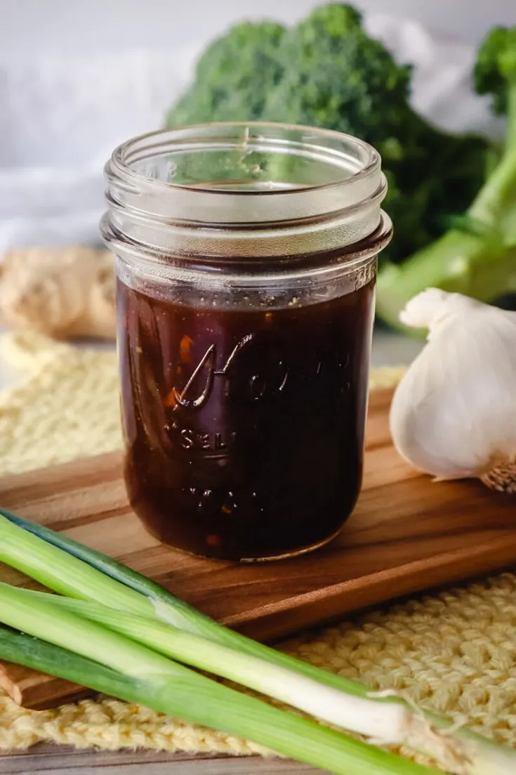 Jar of keto teriyaki sauce with broccoli