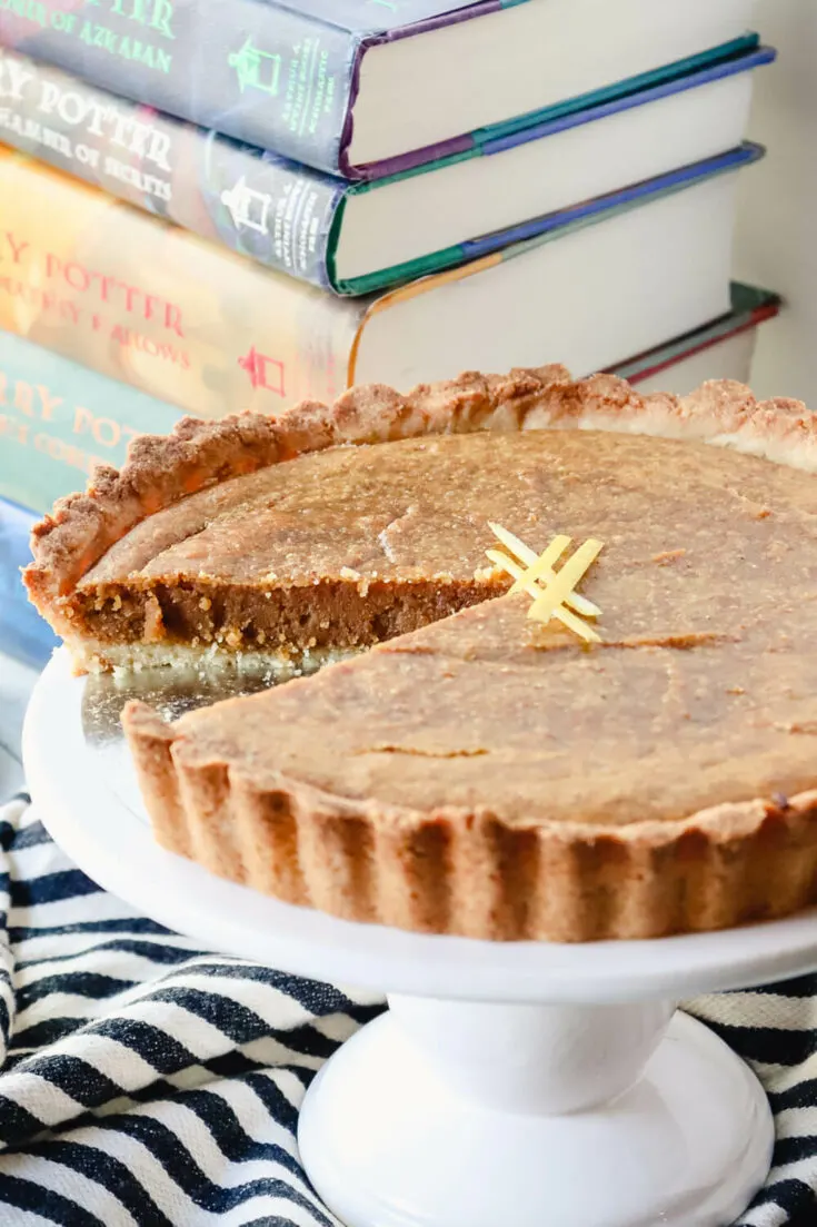 Piece cut out of the keto treacle tart with books in background