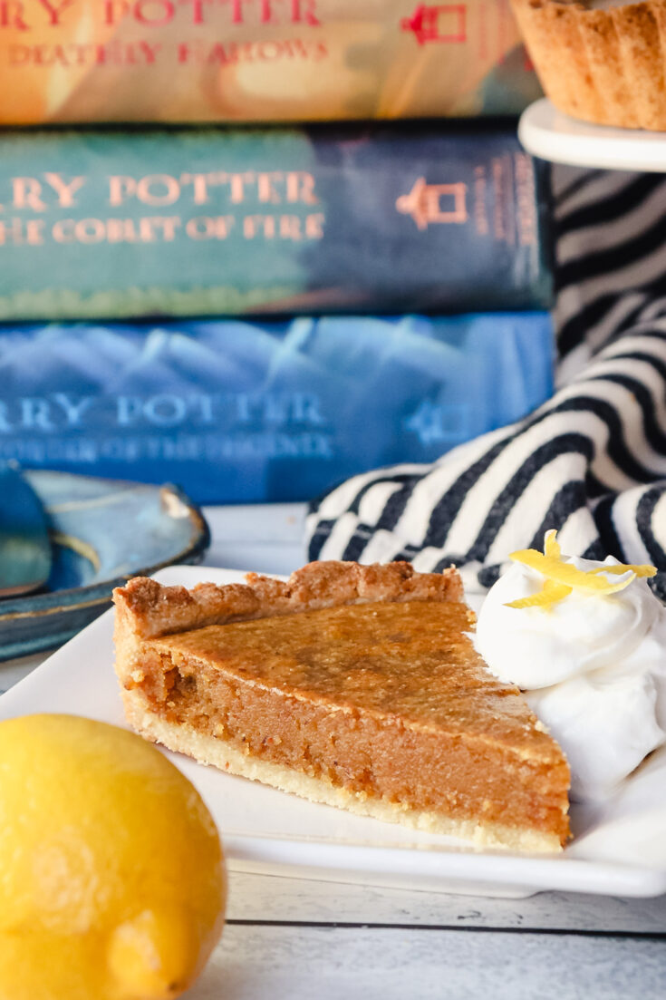Keto treacle tart with whipped cream and Harry Potter books in background