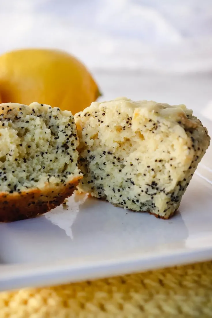 Keto lemon poppy seed muffin in half on a white plate