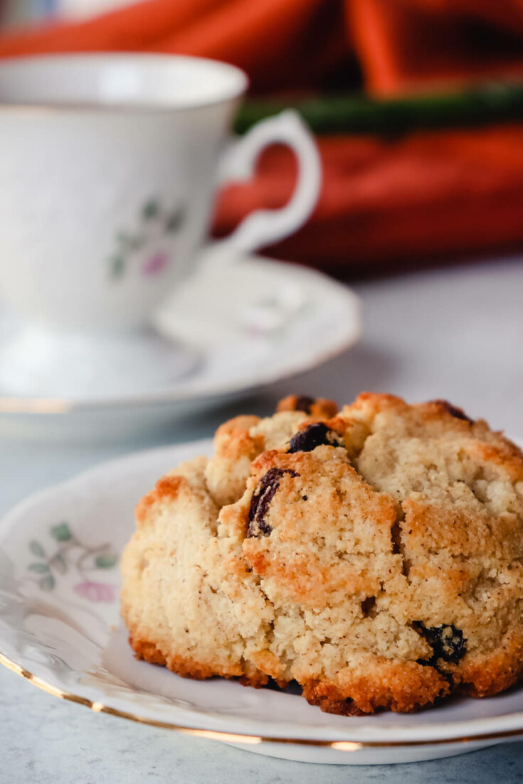 keto rock cake on a plate in front of a cup of tea