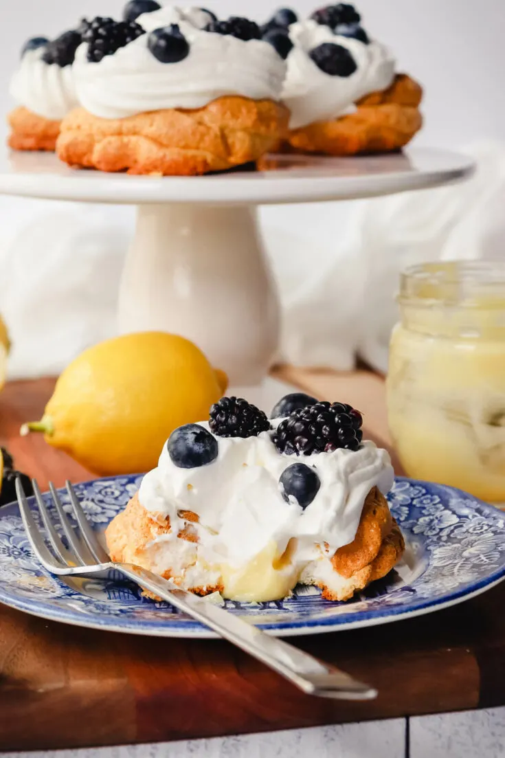 Keto lemon curd meringue nests on a plate and pedestal