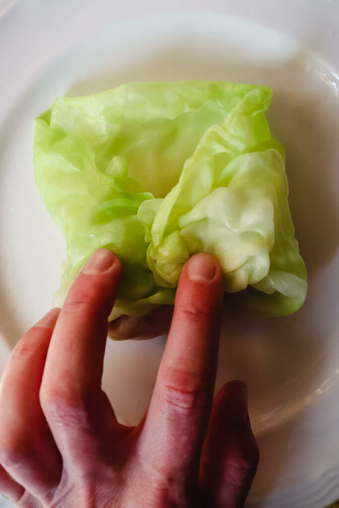 Folding in the cabbage leaf over the filling