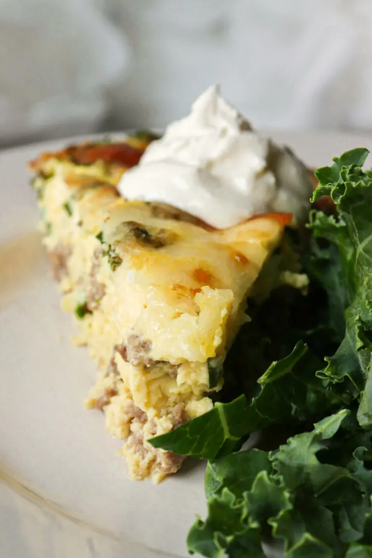Front view of a piece of keto sausage quiche
