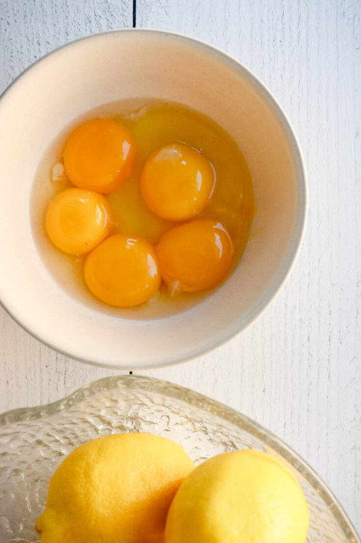 Egg yolks in a saucepan overhead view