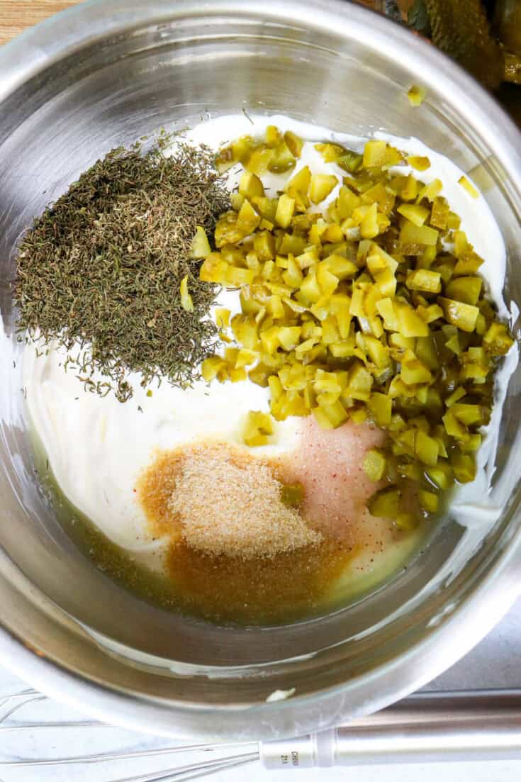 Overhead view of metal bowl with dill dip ingredients