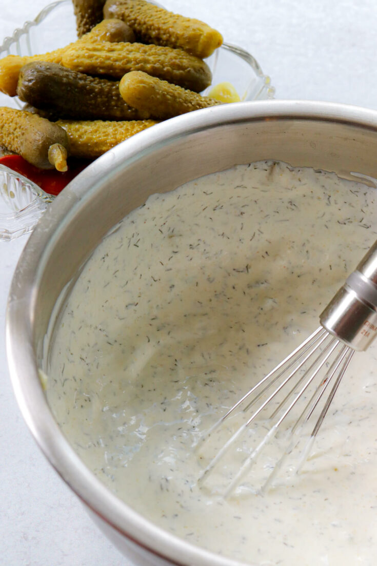 Mixed keto dill dip with a whisk in the bowl