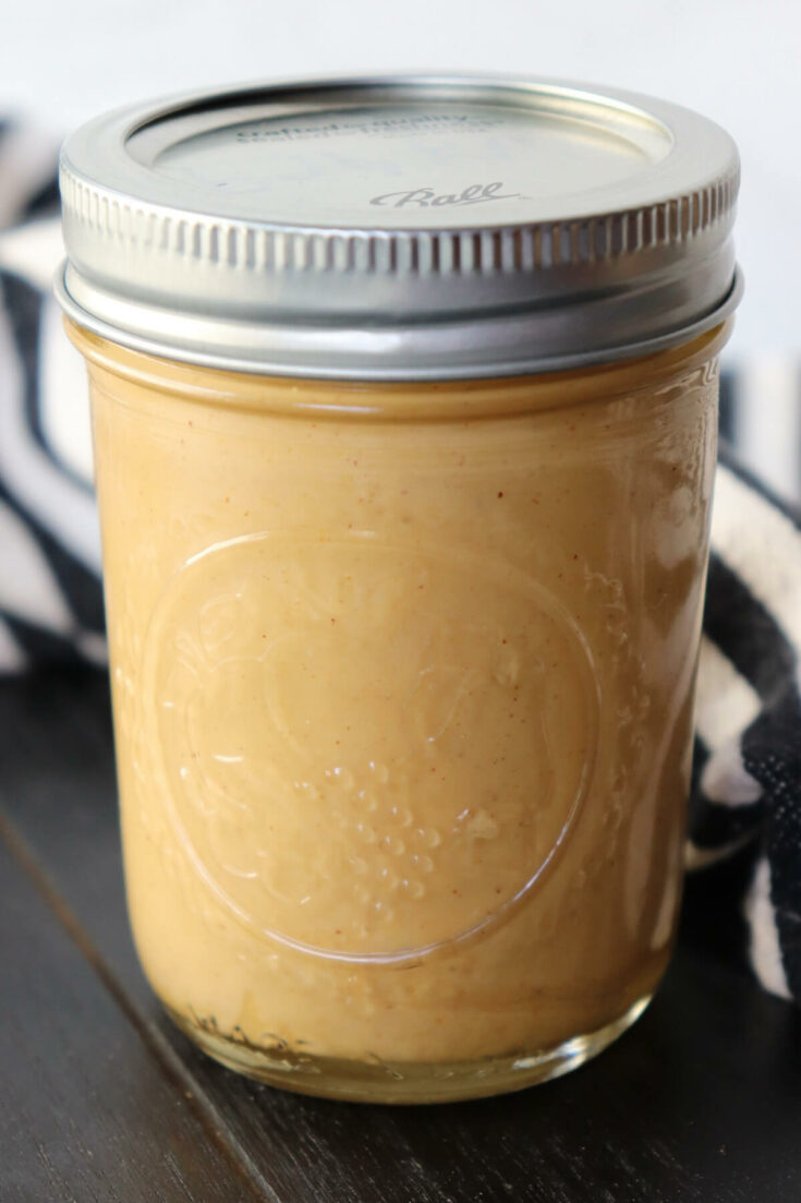 Side view of a closed jar of homemade peanut butter