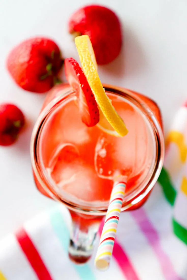 Overhead view of a glass of ketogenic lemonade with strawberries