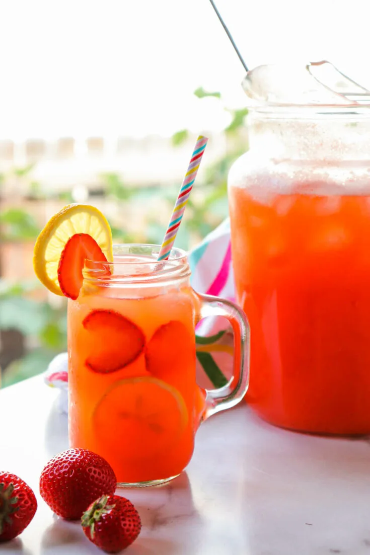 A pitcher and glass of keto strawberry lemonade