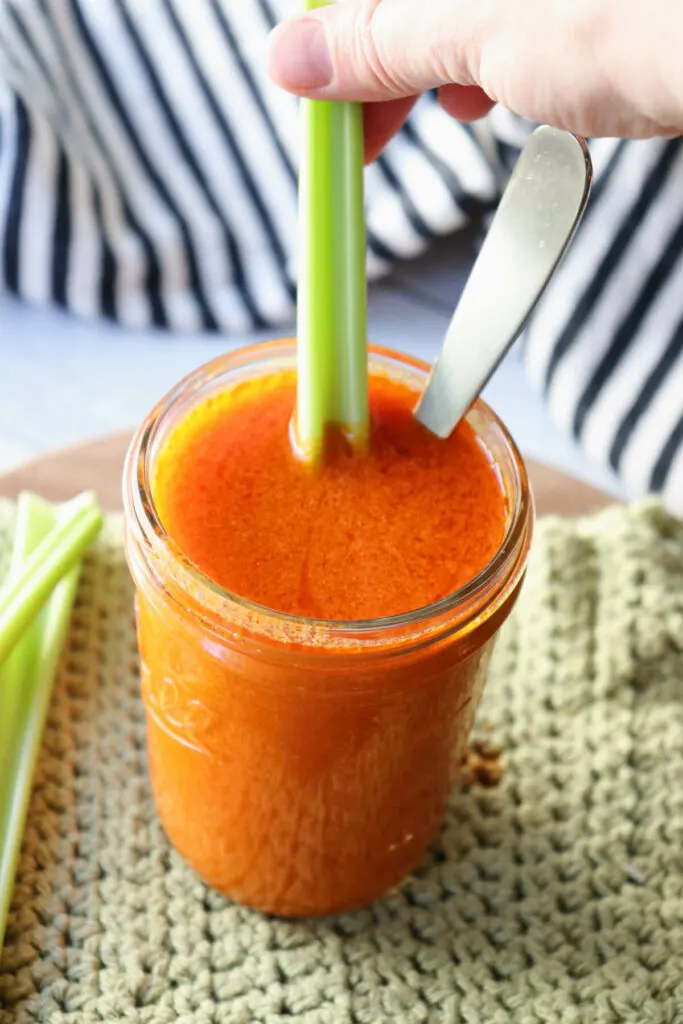 Celery in the jar of low carb Buffalo sauce
